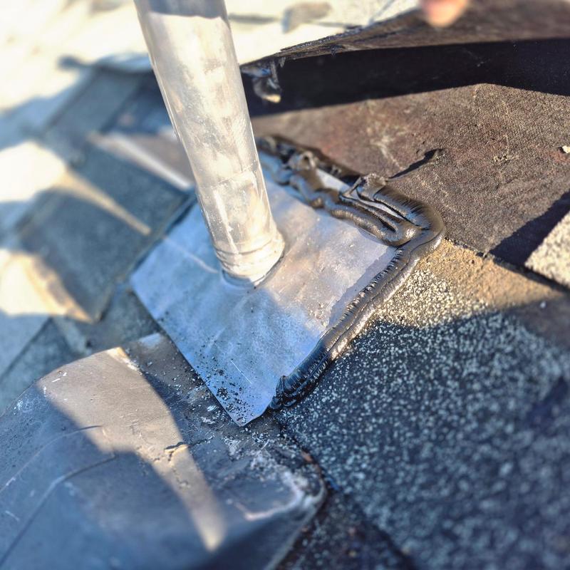 Pipe boot flashing with sealant on roof shingles