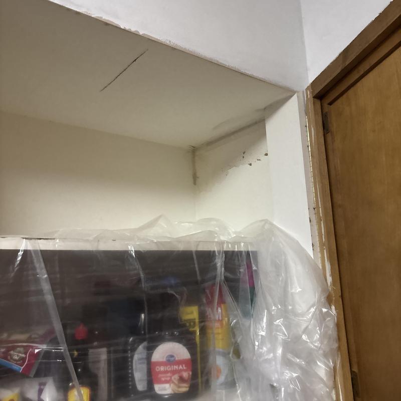 Drywall corner damage with plastic covering nearby items Drywall corner damage with plastic covering nearby items