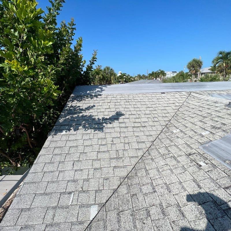Shingle roof with storm damage and patch repairs