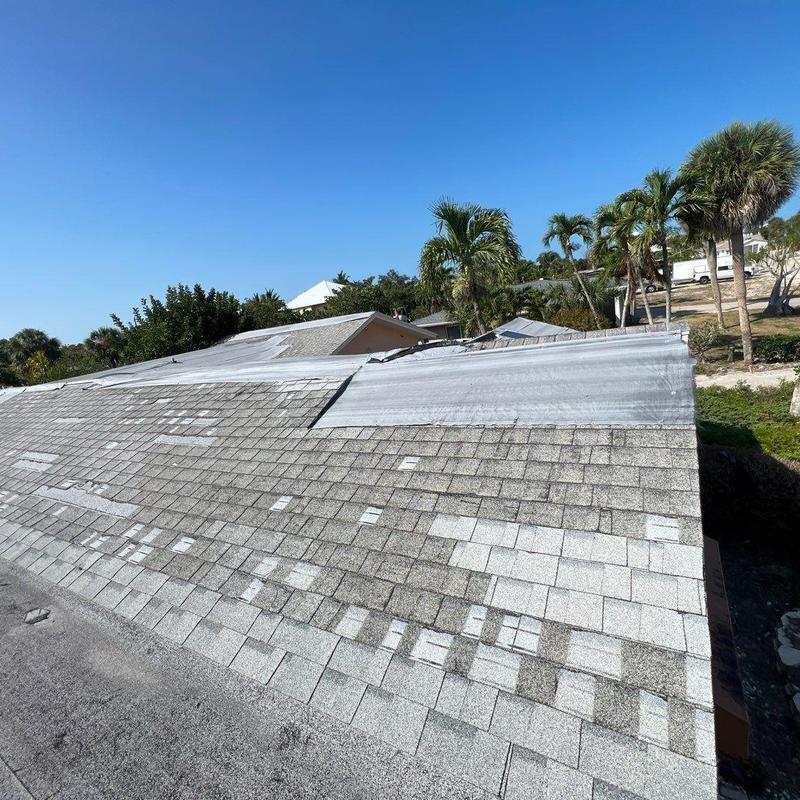 Shingle roof with patchwork repairs and storm damage