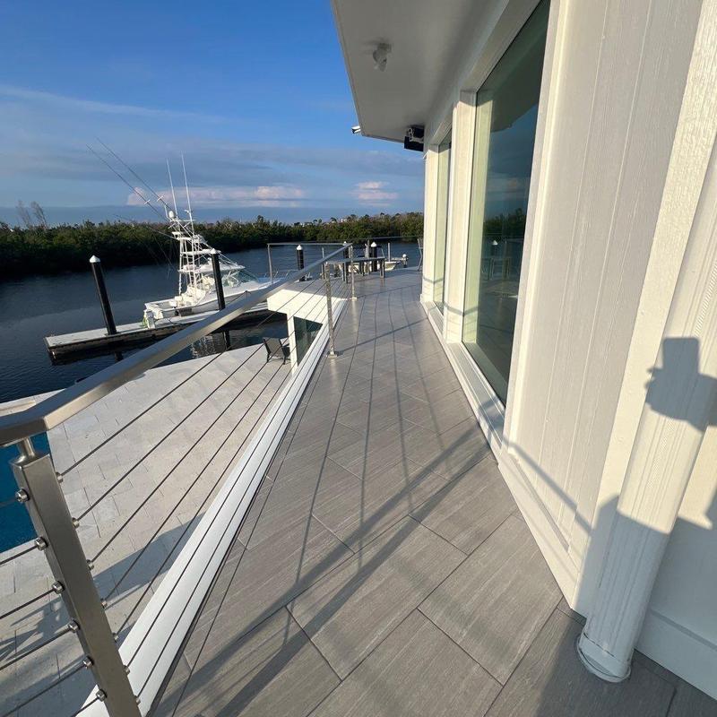 Flat roof deck with stainless cable railing and tile flooring