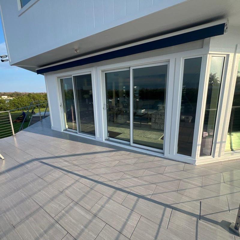 Flat roof deck with sliding glass doors and railing