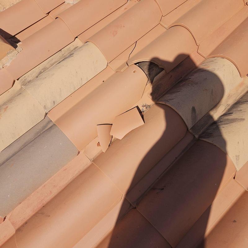 Tile roof with cracked and broken tiles