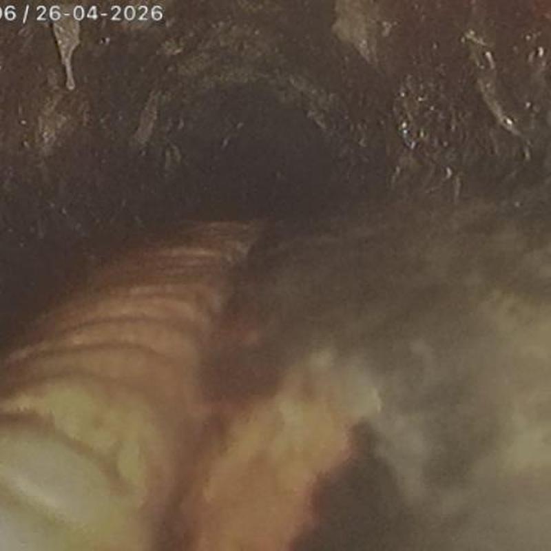 Cast-iron mainline pipe interior with buildup and debris