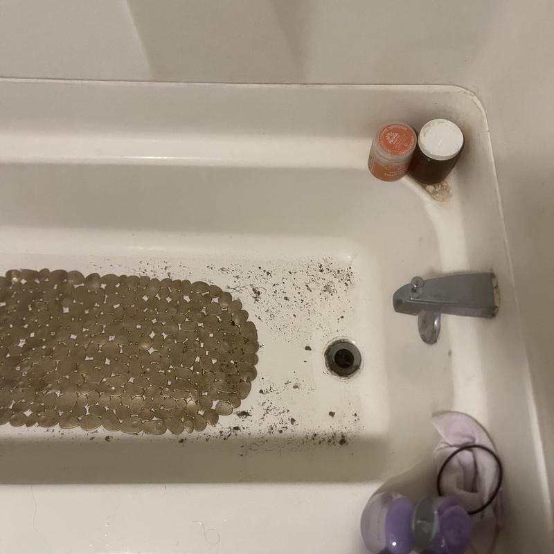 Bathtub drain with dirt and debris buildup