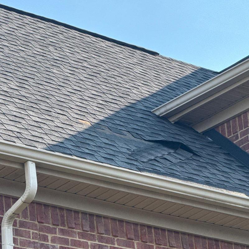 Roof shingles with hail damage and blistering on slope