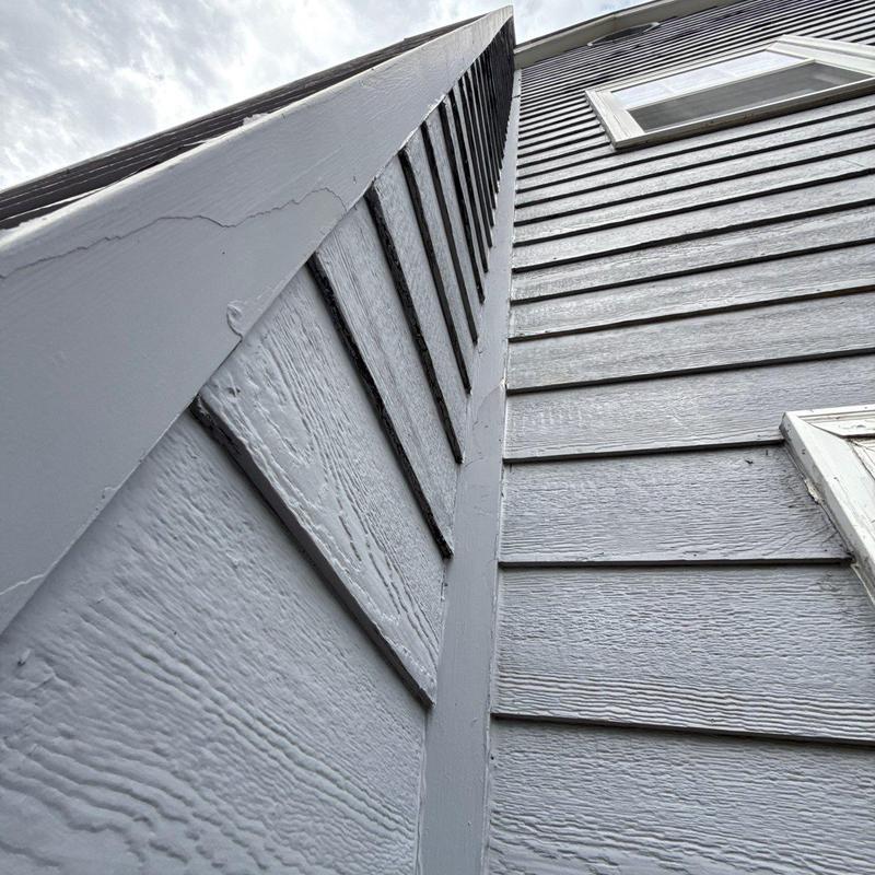 Exterior siding panels with corner trim and window frame