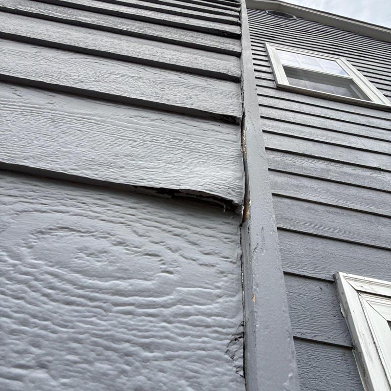 Wood siding warping and damage near window trim