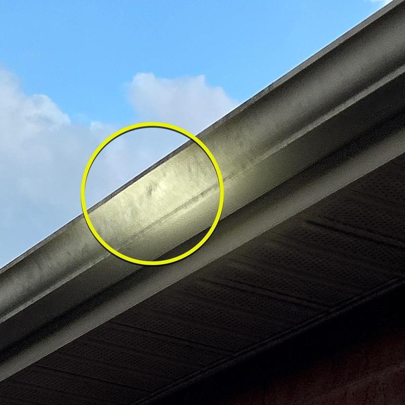 Aluminum gutter dented from hail damage