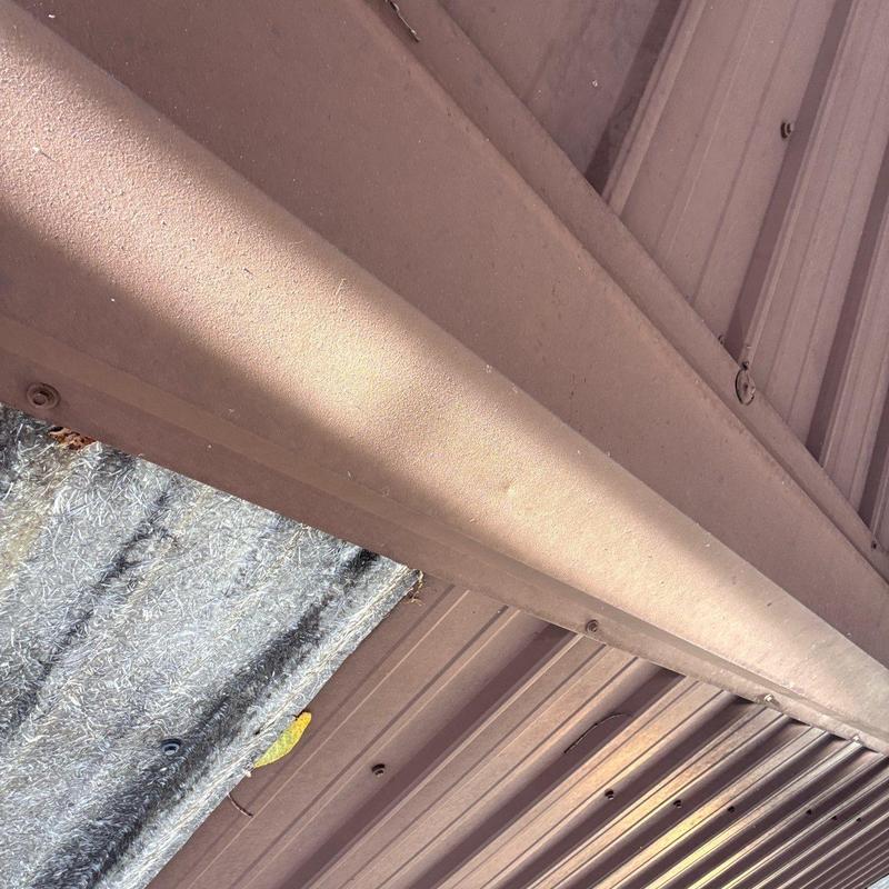 Metal roofing panel and gutter system under sunlight