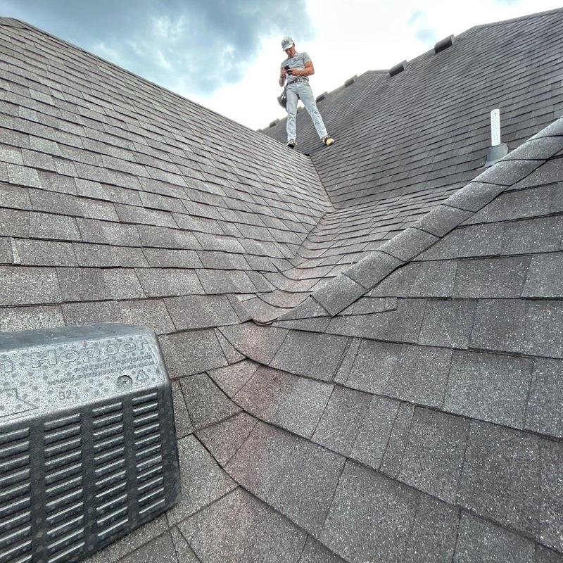 Asphalt shingle roof with hail damage inspection