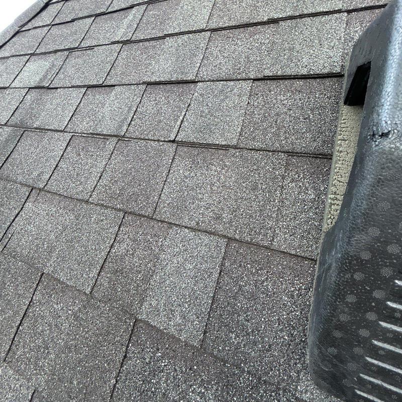 Asphalt shingle roof hail damage near vent pipe