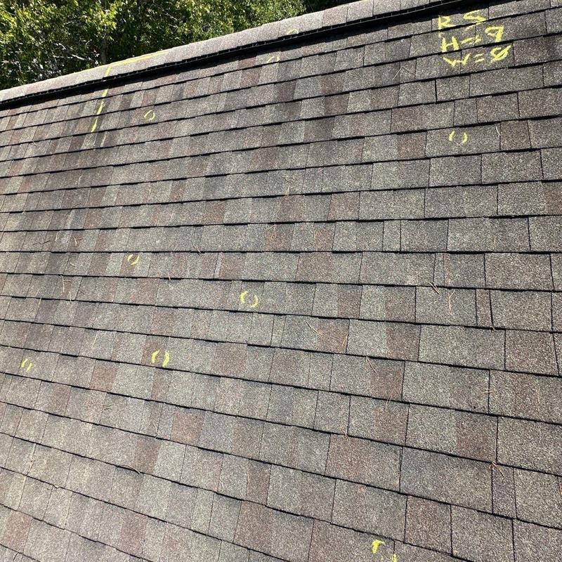 Asphalt shingle roof with marked hail damage areas