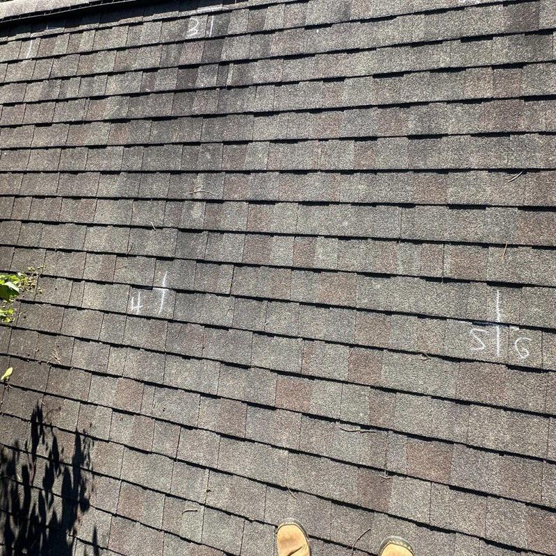 Asphalt shingle roof with chalk-marked hail damage