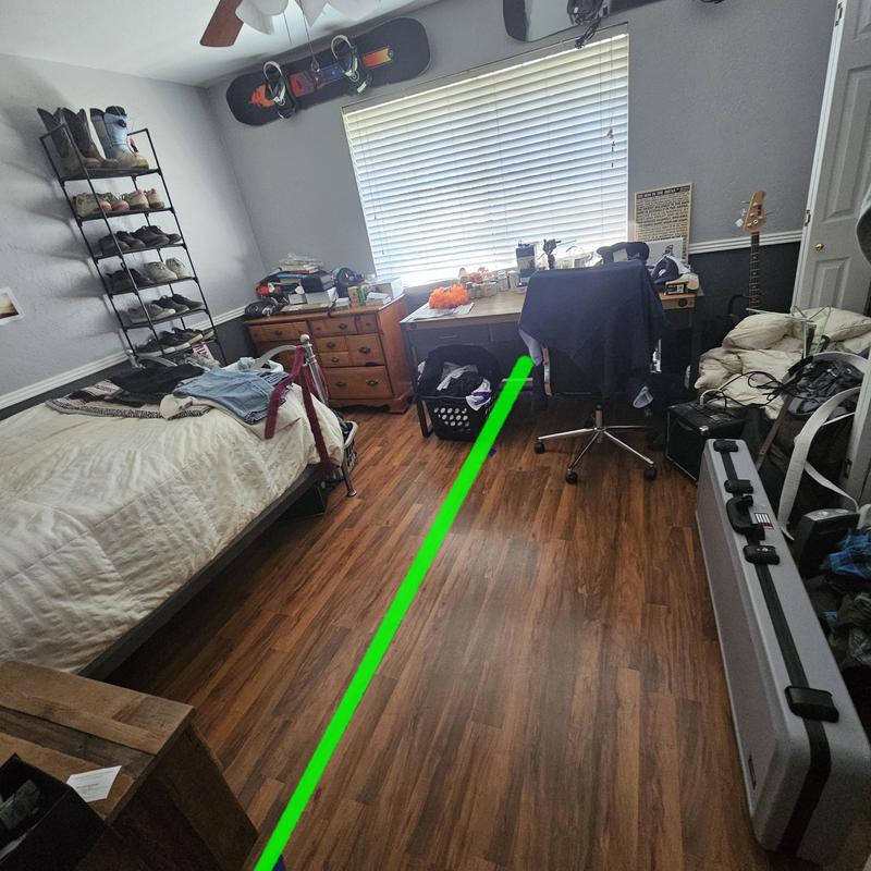 Wood laminate floor with green guide line in bedroom Wood laminate floor with green guide line in bedroom