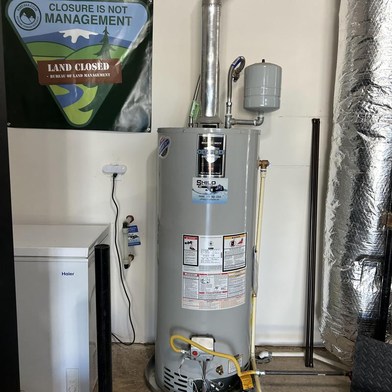 Water heater with attached expansion tank and vent pipe