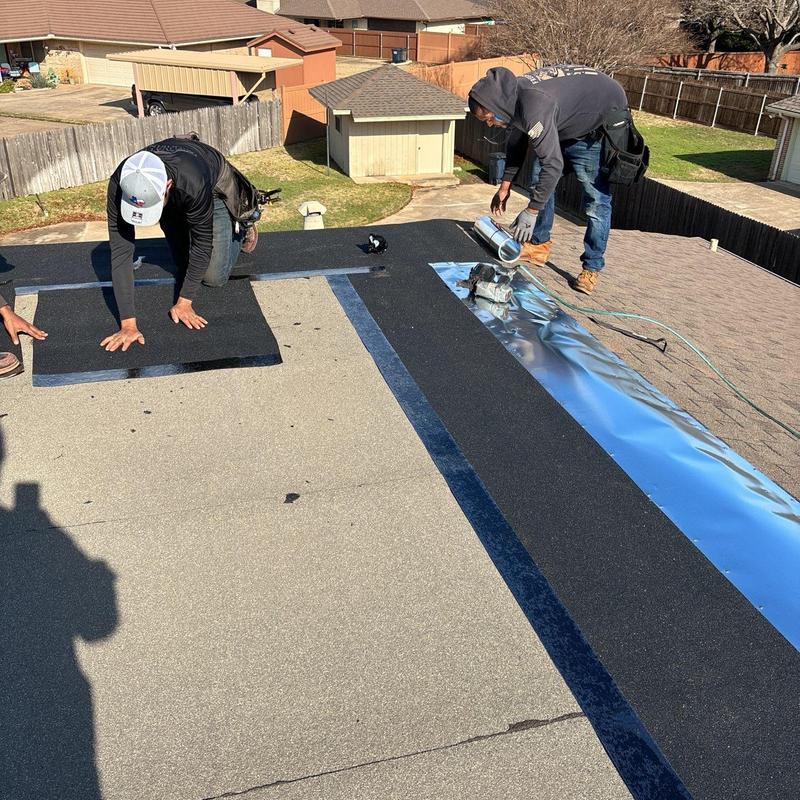 Modified bitumen roof installation on flat residential roof