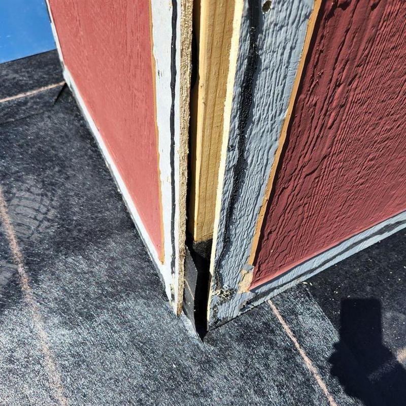 Chimney flashing and siding removal at roof edge