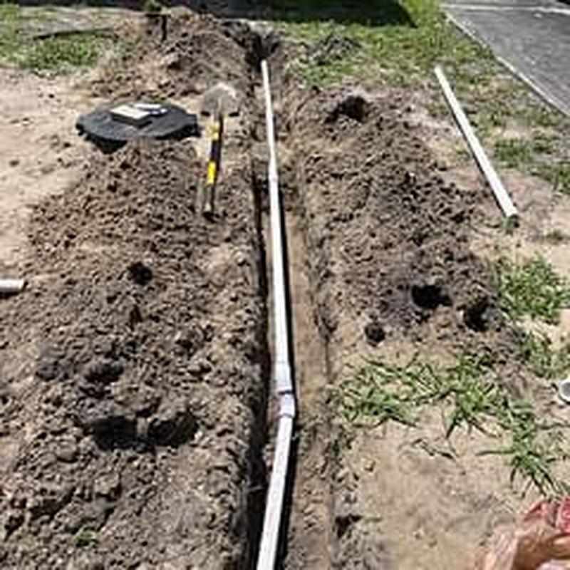 PVC laundry drain line installation in yard trench