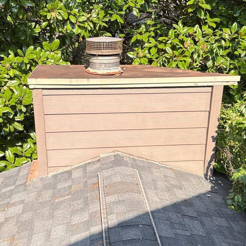 Roof shingles and ventilation cap with rust and debris