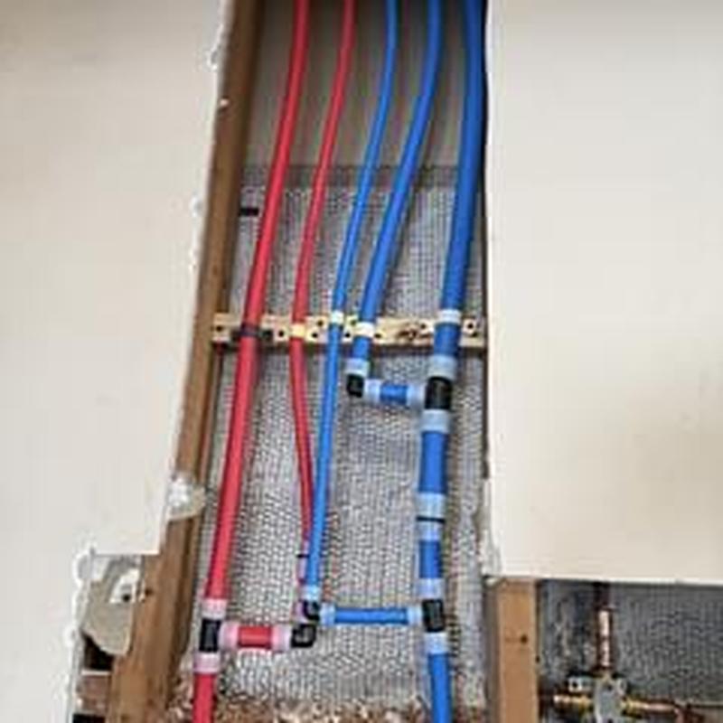 Pex A water pipes with fittings installed behind drywall