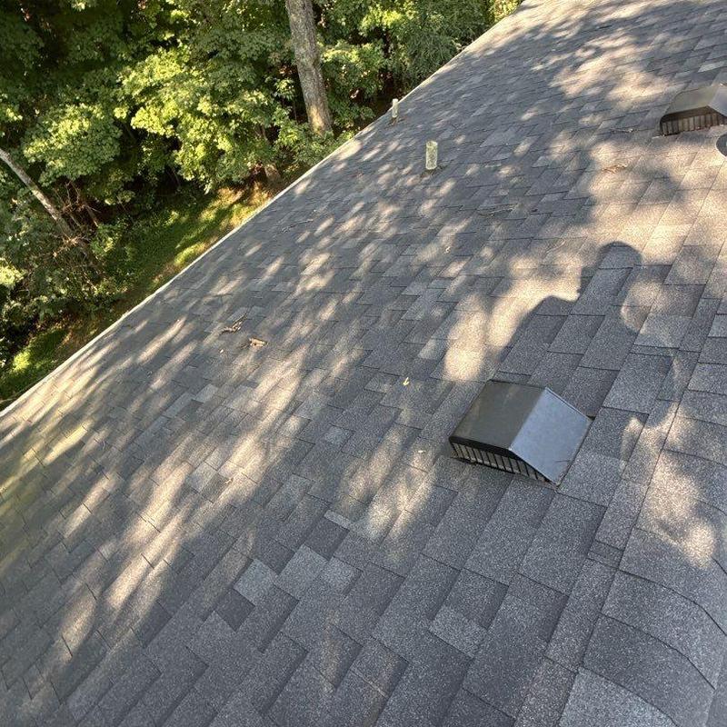 Asphalt shingle roof with ventilation vent and flashing