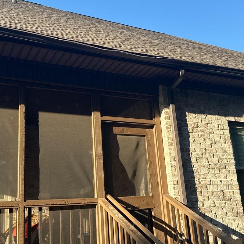 Roof shingles and gutters with visible damage on house exterior
