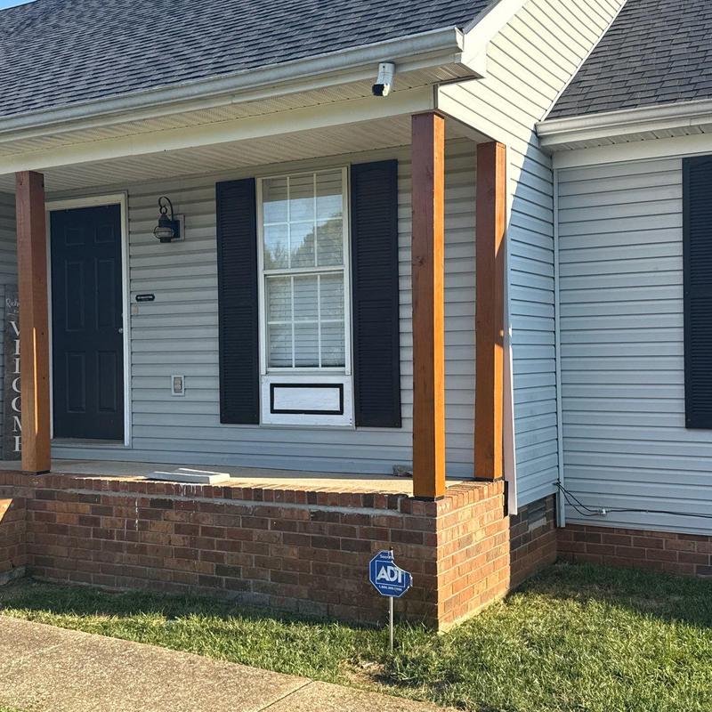 Window shutter and siding installation on porch exterior