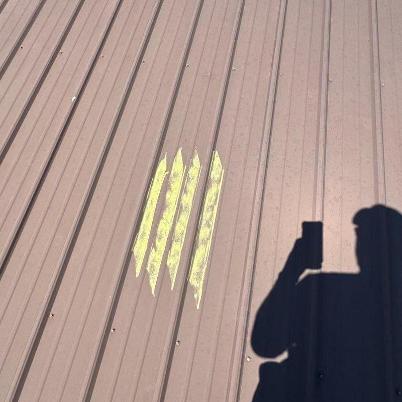 Metal roof panels with marked hail damage areas