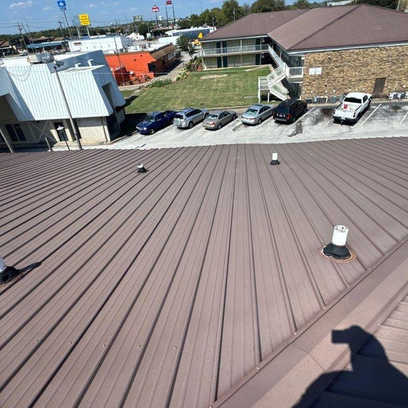 Metal commercial roofing with hail damage and vents