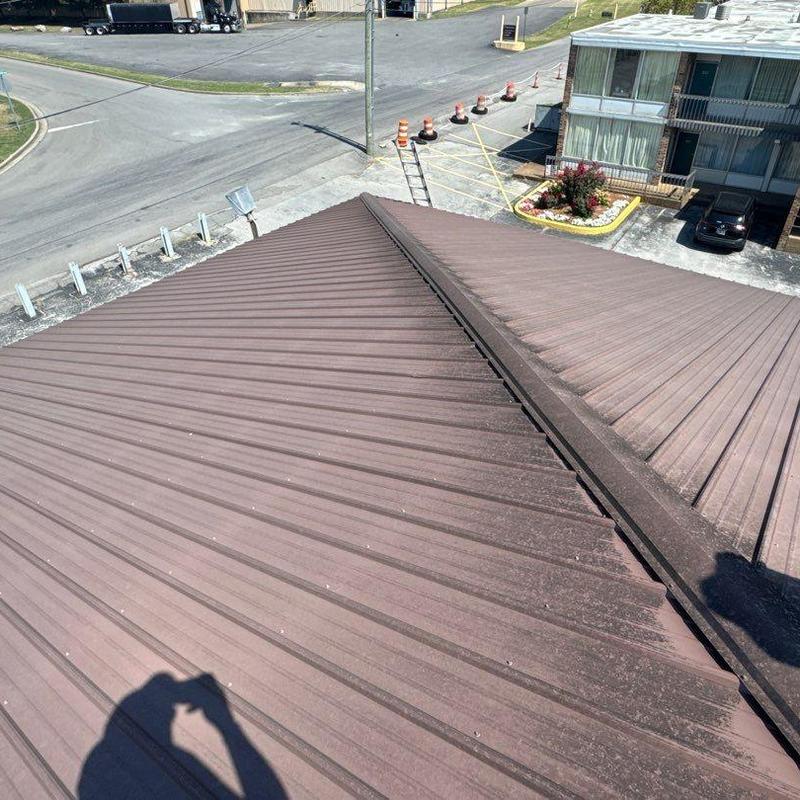 Metal roofing with hail damage inspection on commercial building
