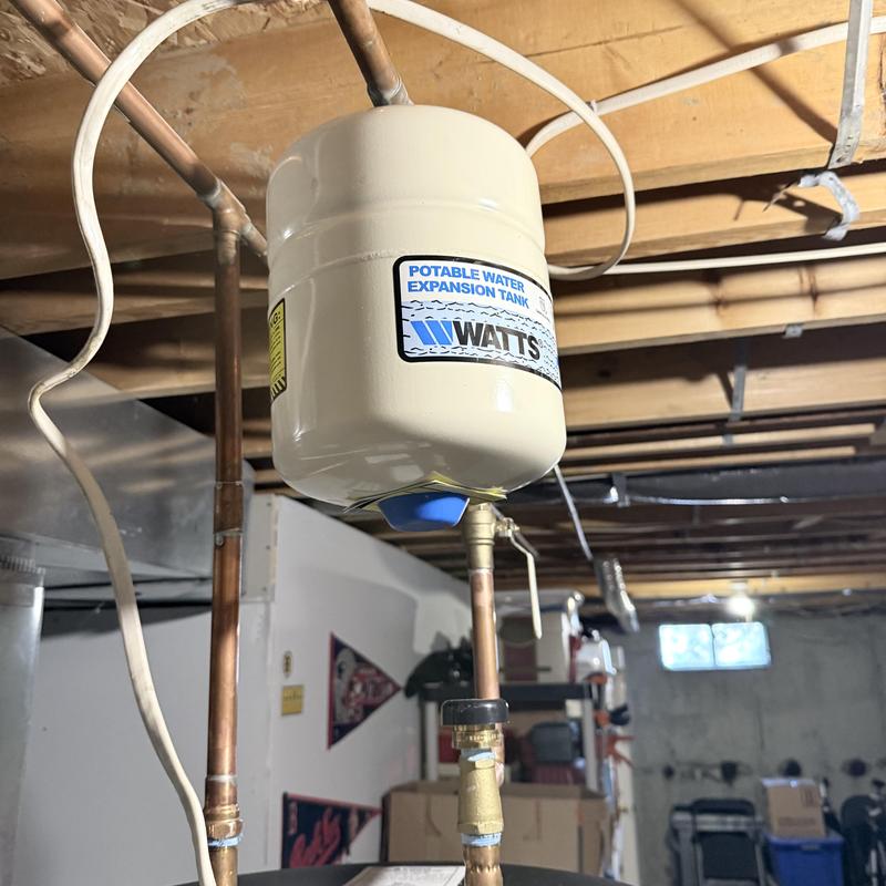 Water heater expansion tank attached to copper piping