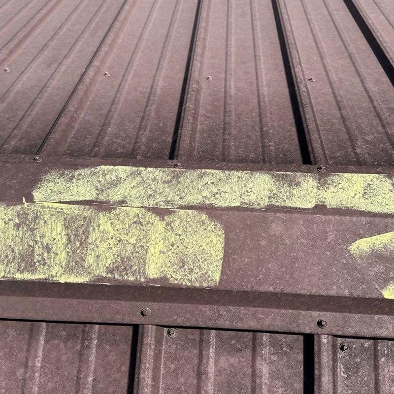 Metal roof panel with hail damage markings