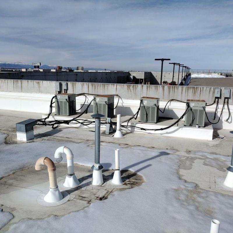 TPO roof pipe jack seals and HVAC units on commercial roof
