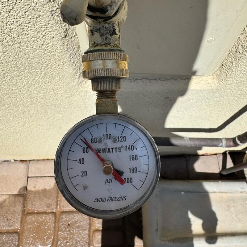 Water pressure gauge showing 78 psi on outdoor faucet