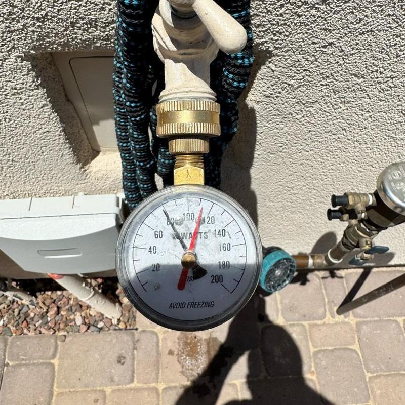 Water pressure regulator gauge with outdoor hose faucet