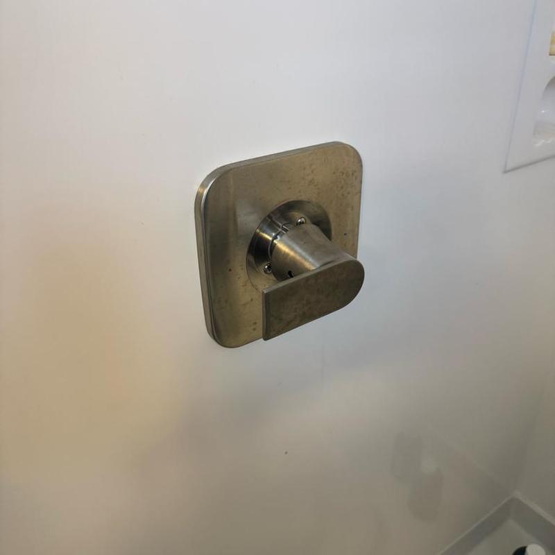 Single handle Moen shower cartridge handle installed on wall