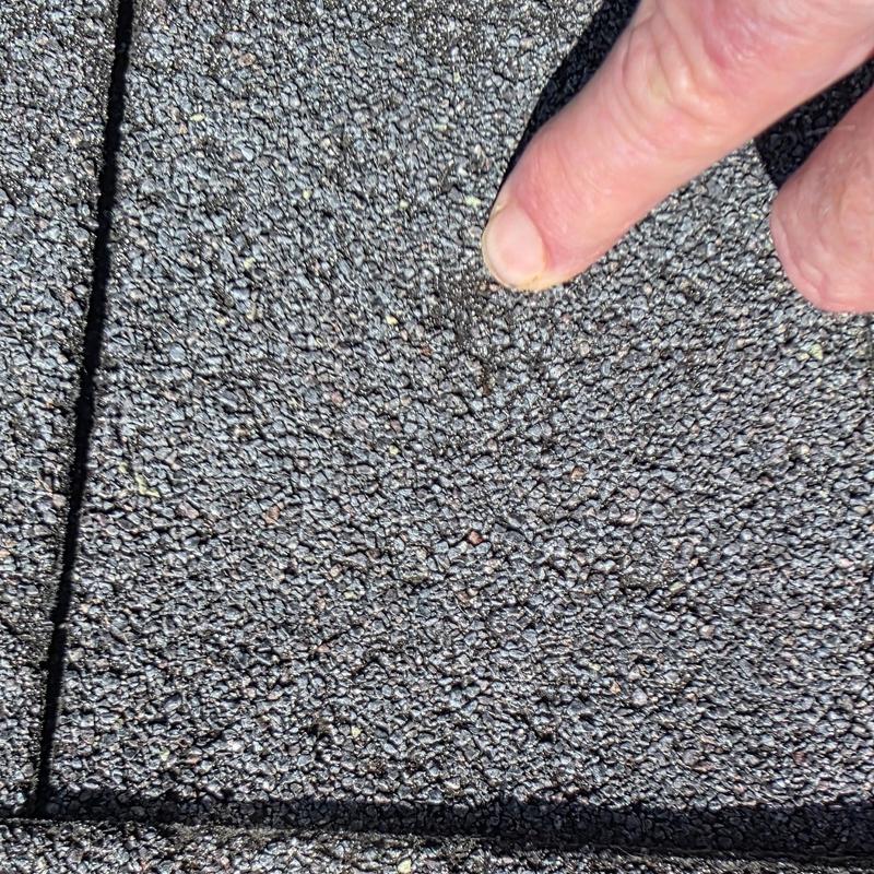 Asphalt shingle roof with hail damage close-up