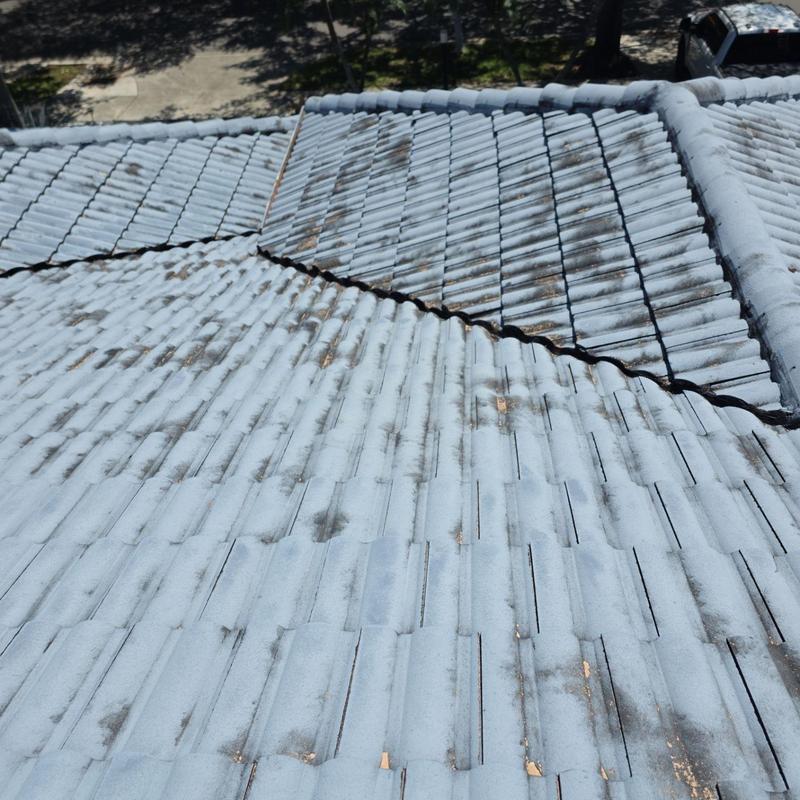 Tile roof with dirt and wear on multiple slopes
