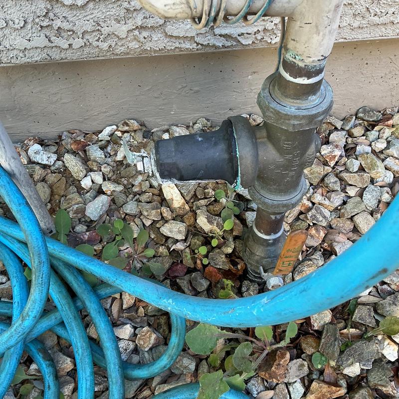 Pressure regulator valve and hose on gravel bed Pressure regulator valve and hose on gravel bed