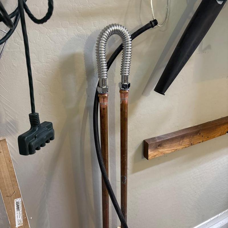 Water softener bypass loop with copper pipes in garage