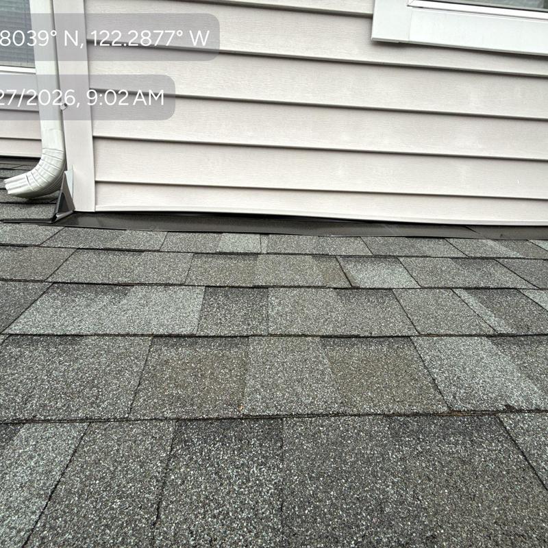 Asphalt shingle roof with wall flashing and gutter downspout