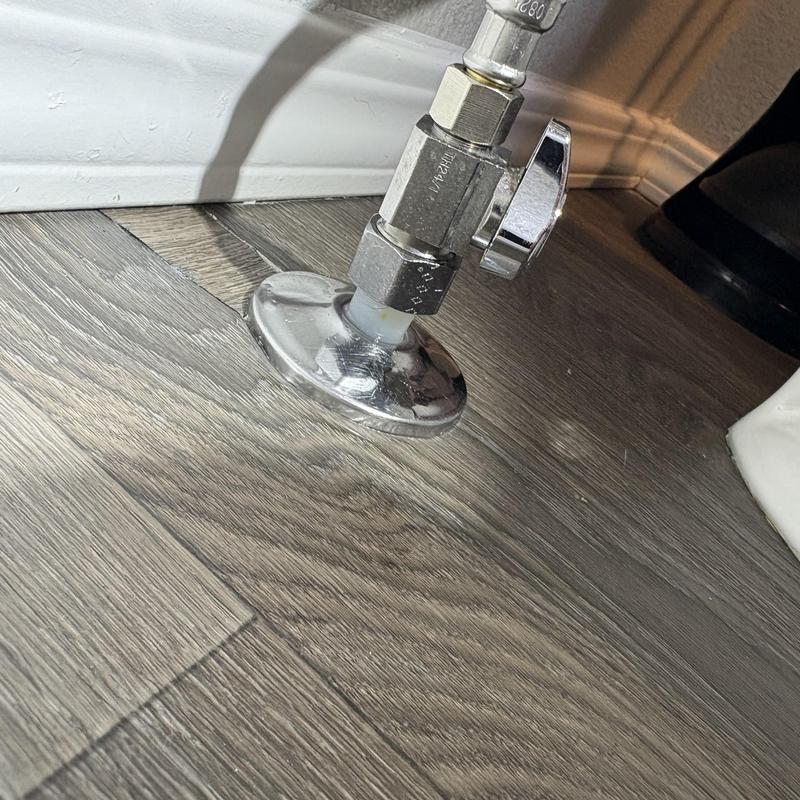 Toilet water supply valve and PEX piping connection on floor