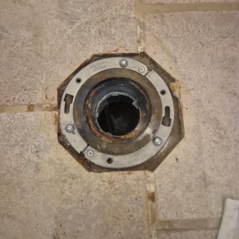 Toilet flange on tiled floor for toilet repair Toilet flange on tiled floor for toilet repair