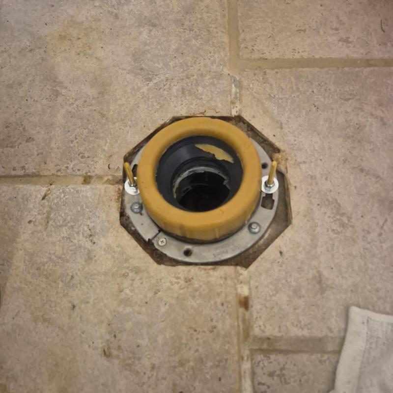 Toilet flange with wax ring removed on tile floor Toilet flange with wax ring removed on tile floor