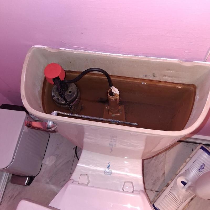 Toilet fill valve inside tank with rust buildup