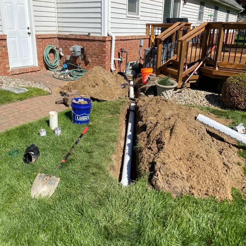 Basement window well drain piping installation outdoors