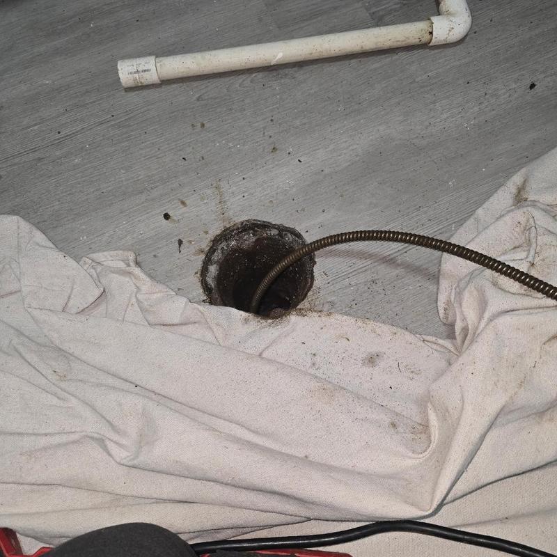 Floor drain with cable clearing root blockage