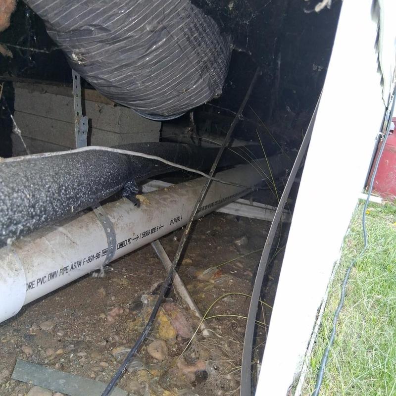 PVC drain pipe installation in crawl space area