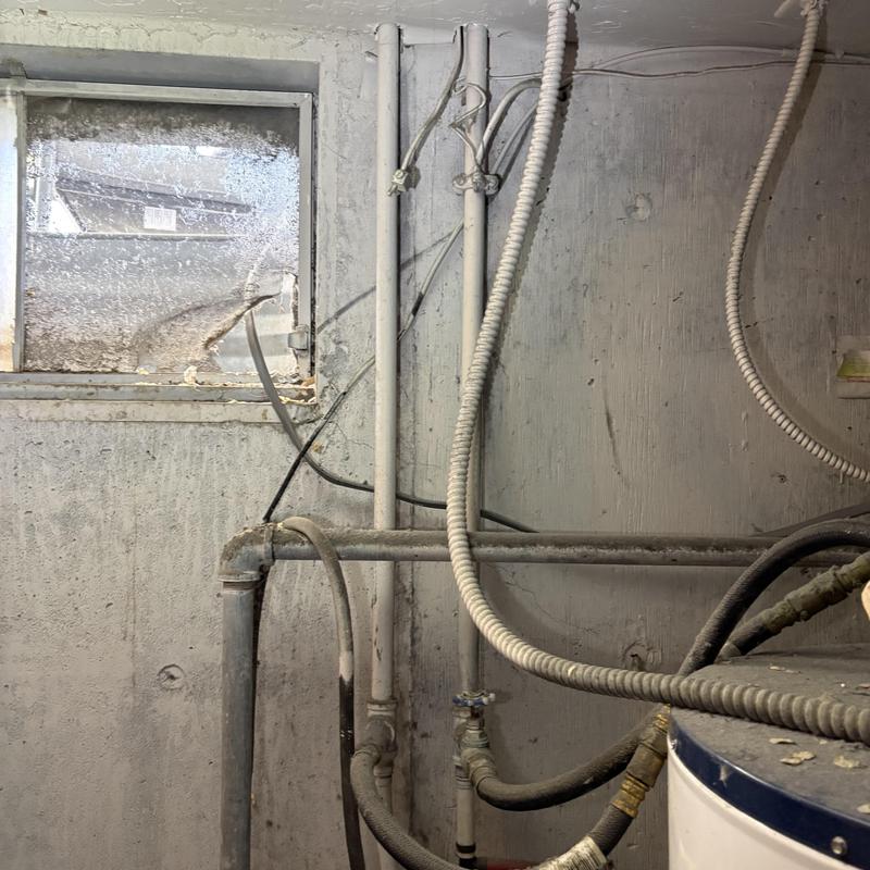 Galvanized water piping with connections in basement